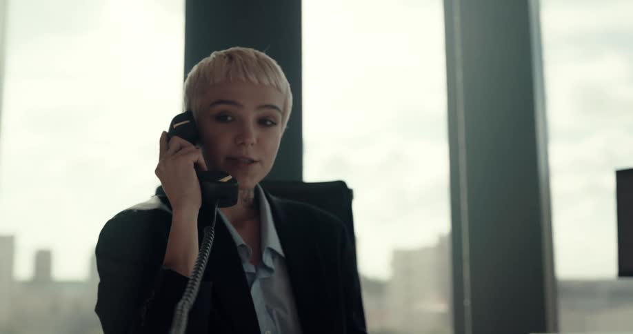A woman answers the phone at her office desk