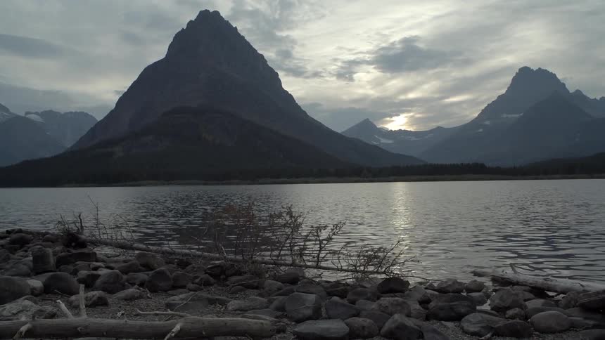 A lake leads to a mountain range