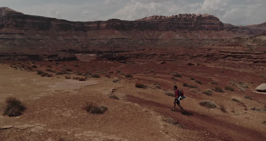 A person is hiking through a valley in spring