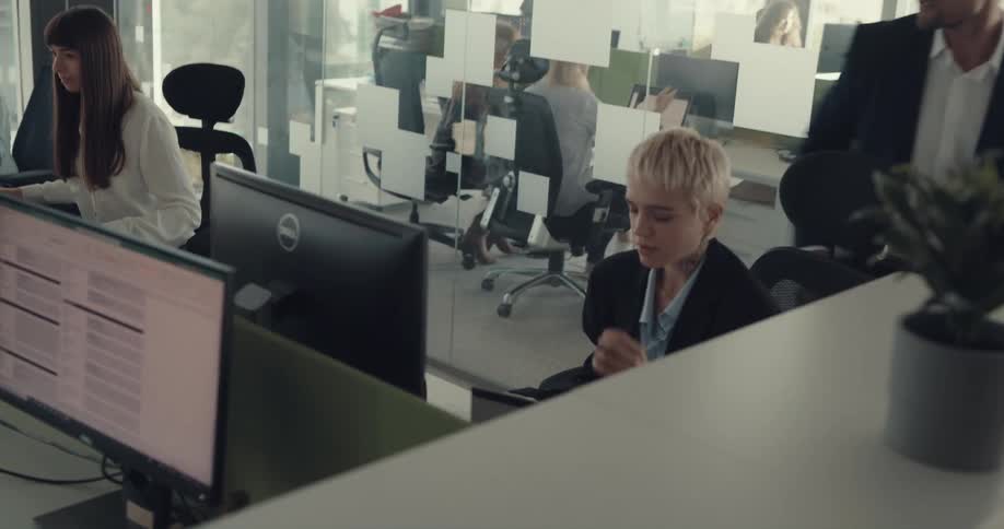 A woman rubs her temples after getting yelled at by her boss