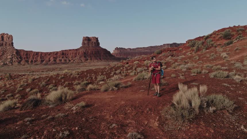 A man is standing in the desert