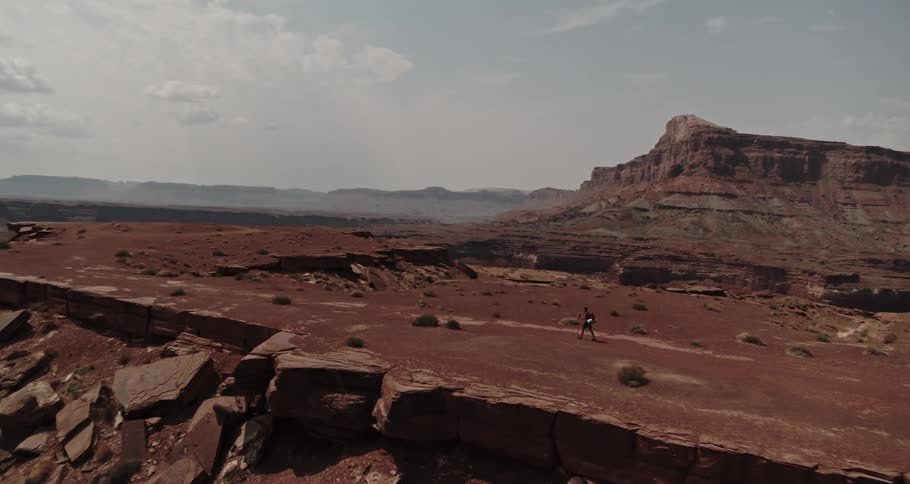 A man hikes along a canyon
