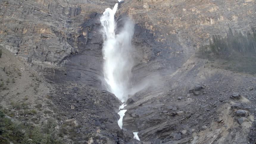 Aerial view of a waterfall dropping into a stream below