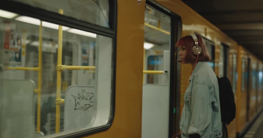 A woman gets on the train