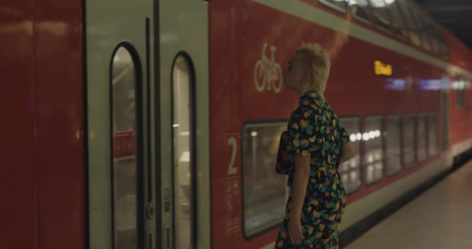A woman frantically runs to a train in the station