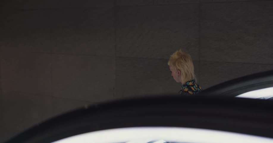 A woman is walking down a staircase in a building