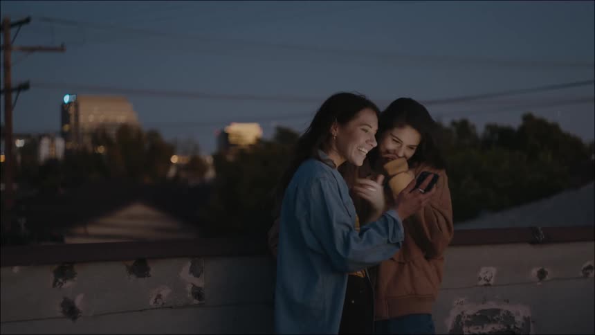 A view of two people talking outdoors on a rooftop