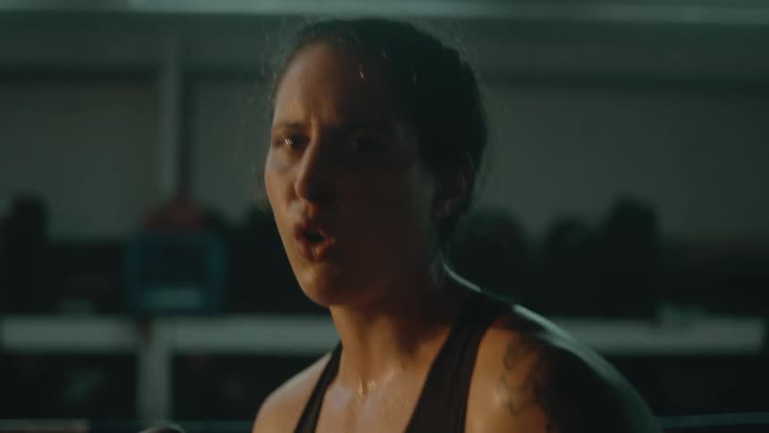 A woman is preparing to box indoors