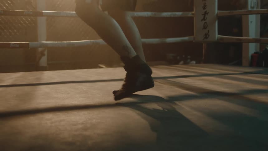 A person is exercising in a boxing ring