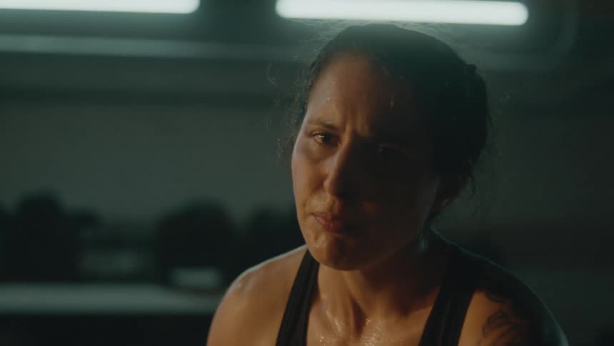 A woman practicing boxing punches in a gym