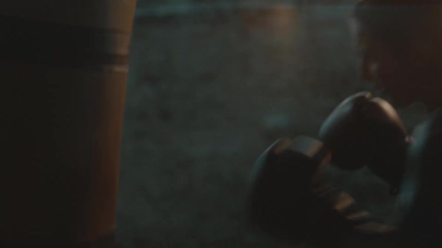 A woman is hitting a punching bag while boxing