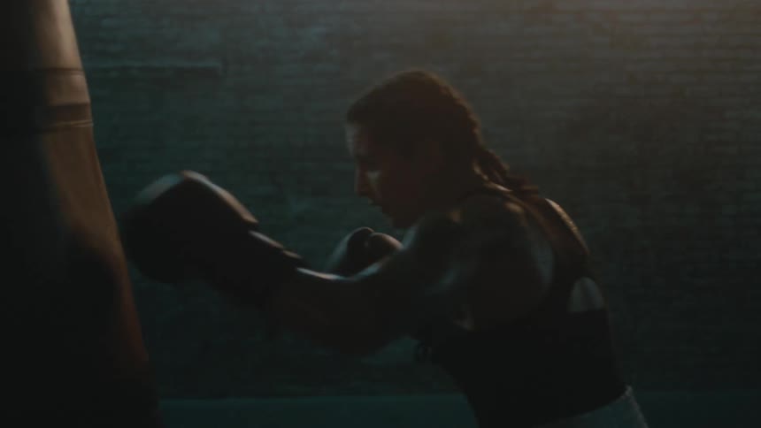 A woman is boxing the heavy bag