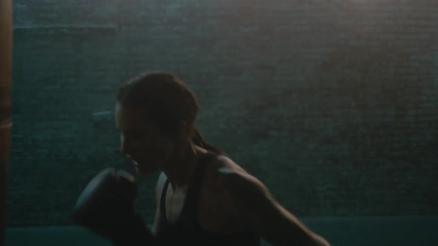 A woman is punching the heavy bag