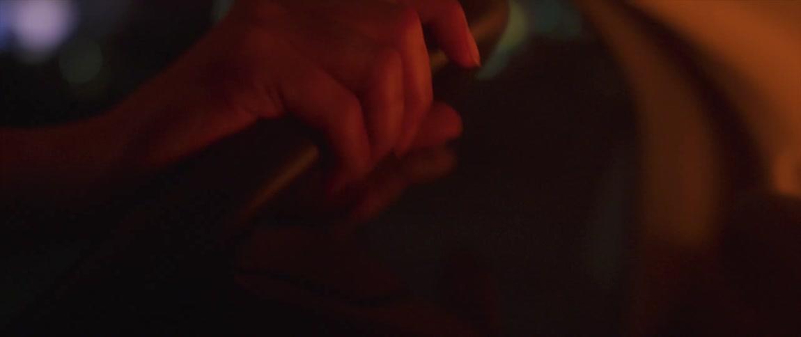 Close up of mans hands grabbing steering wheel driving vehicle at night