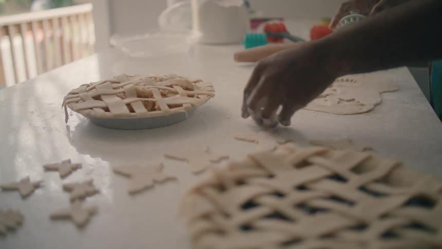 A person is cutting flour with cookie cutter