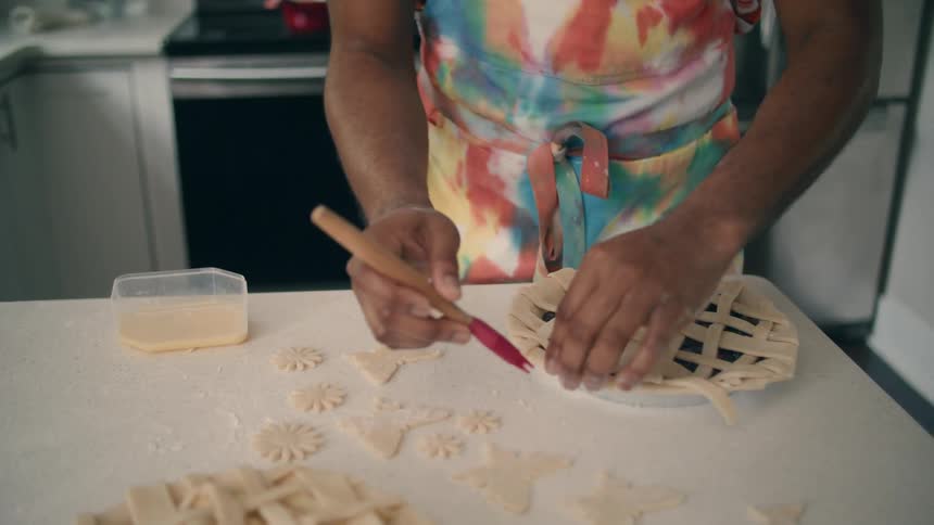 A man is preparing a pie to be cooked