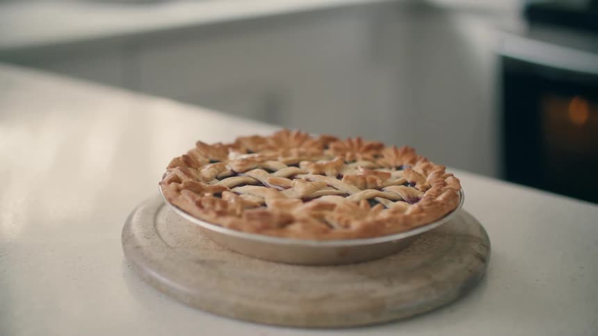 A baked pie is cooling off on a counter top