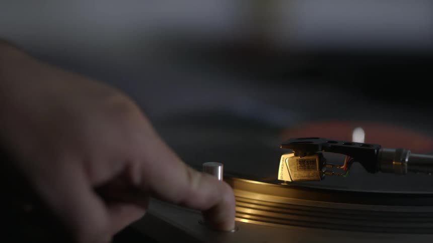 A person turns on a record player