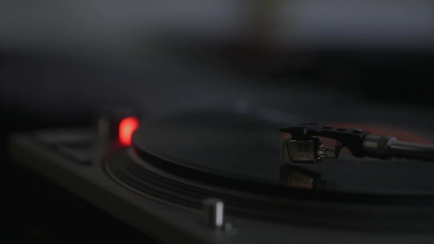 Someone pushes a button on a record player
