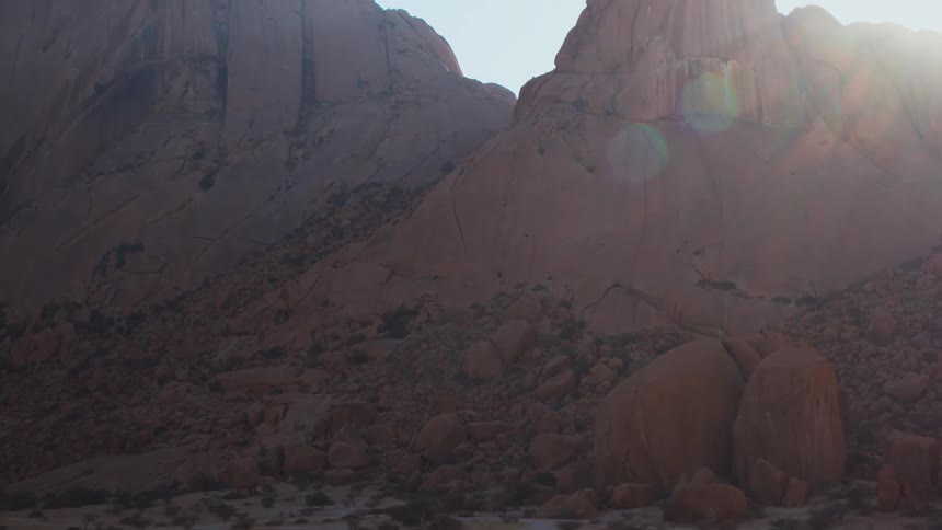 Aerial over desert mountains and giant boulders