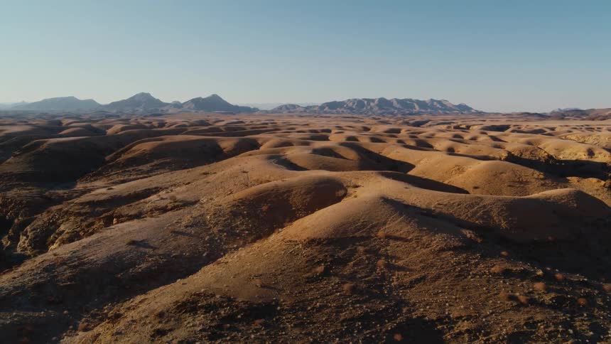 Aerial over rolling desert hills