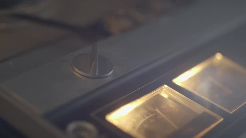 Close up of a tape machine with the dials moving
