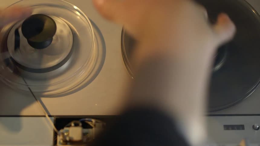 A person spools a tape