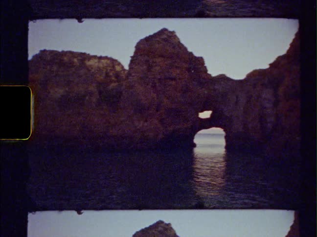 A rock formation stands out from beneath coastal ocean water