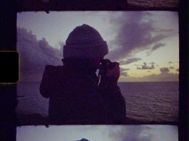 A person taking a photo of the ocean