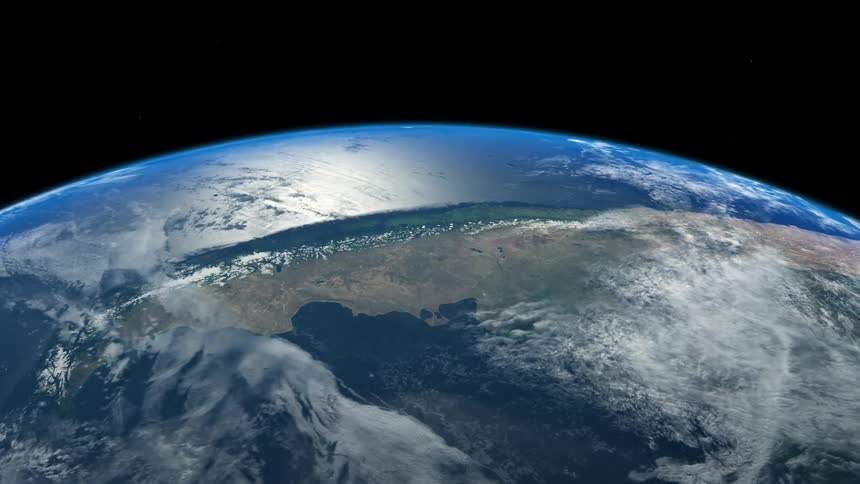 Terrain on earths surface is visible against the night sky