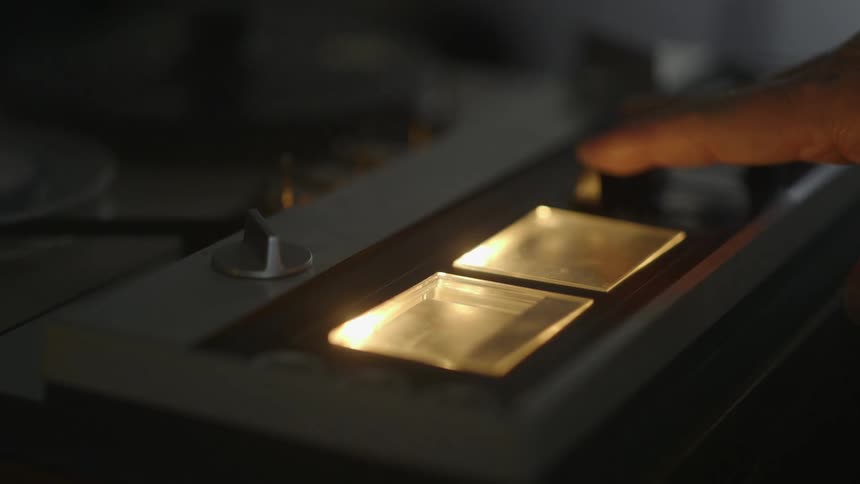 A person turns on and adjusts a tape player