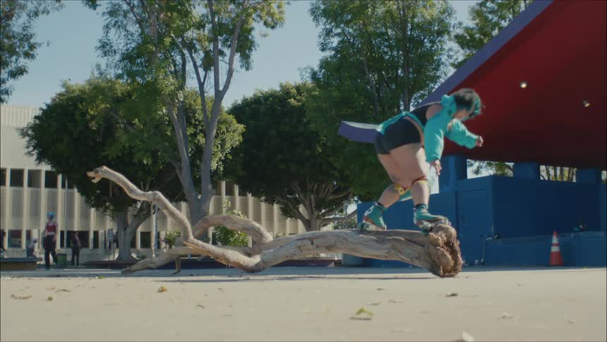 A person jumps on the tree while skating