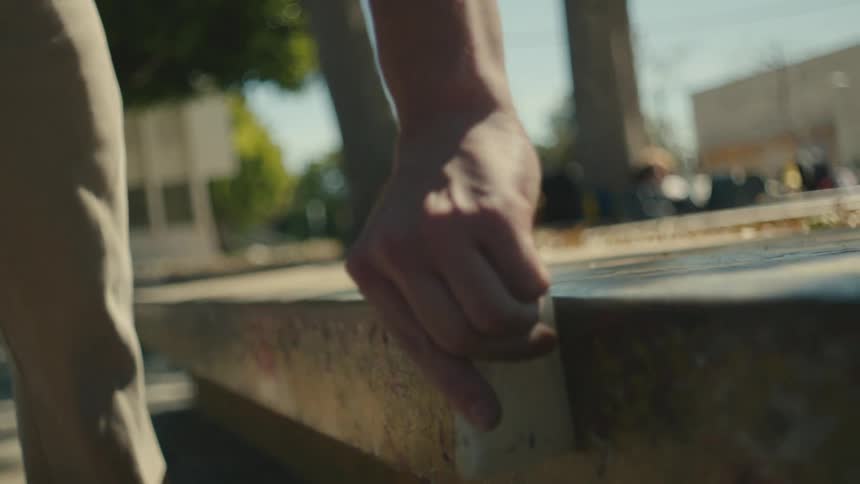 A view of a person waxing a curb