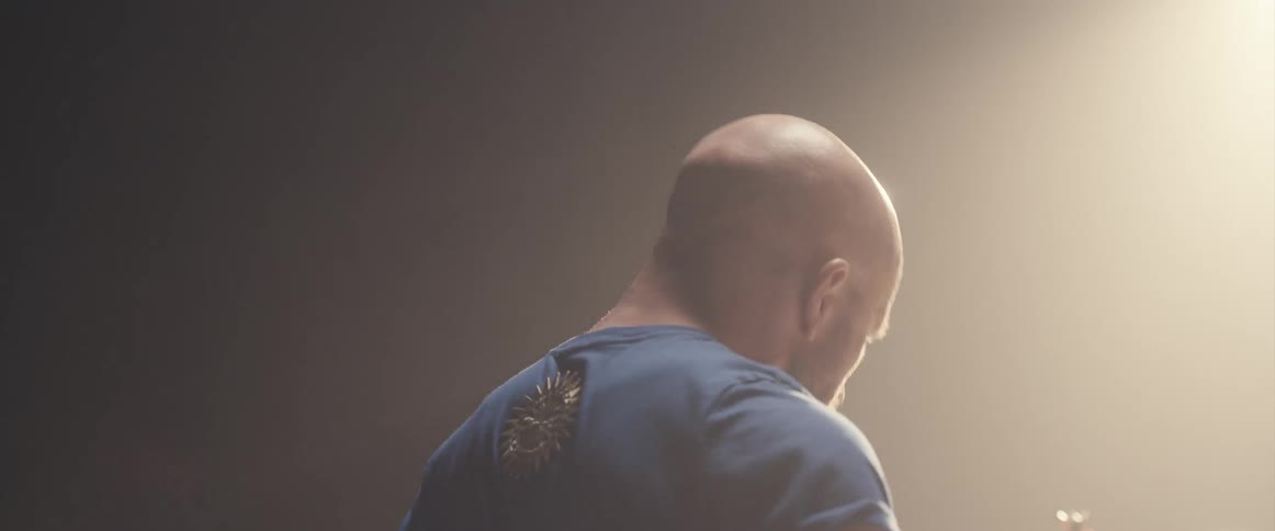 A man is playing the drums on a stage