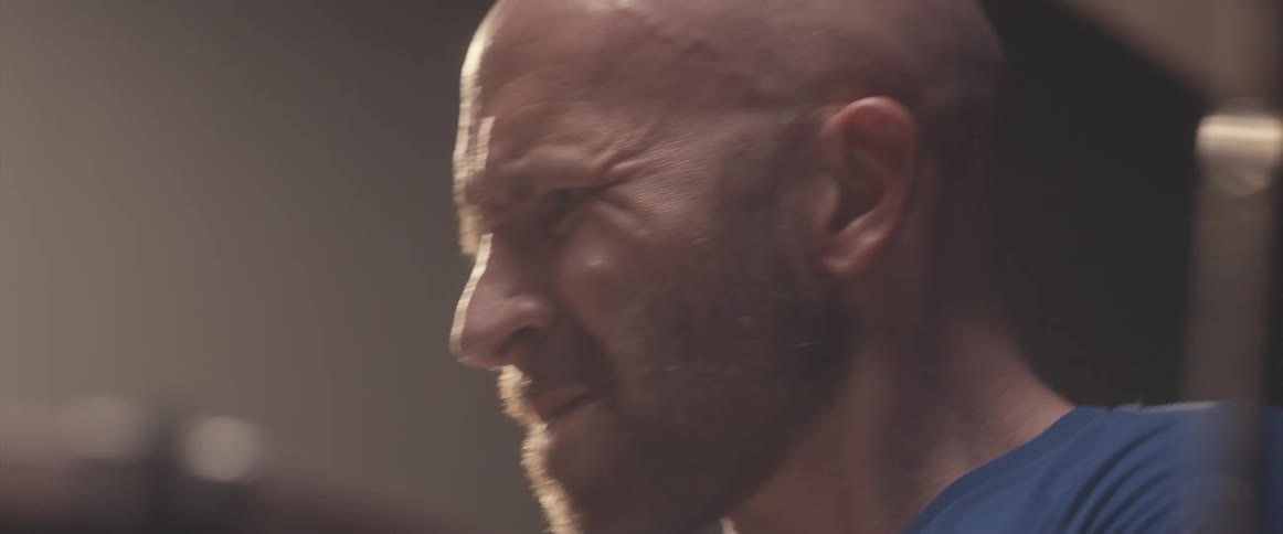 A man is playing the drums in a room