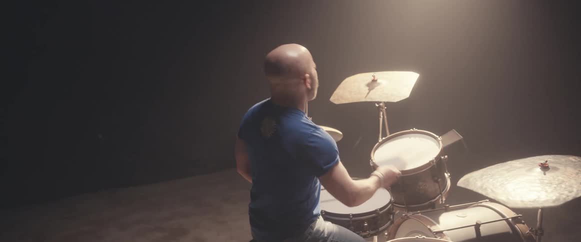A man is playing the drums