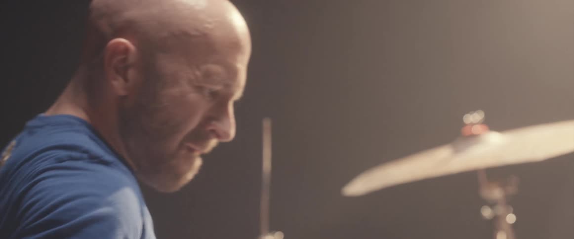 A man playing drums in a studio