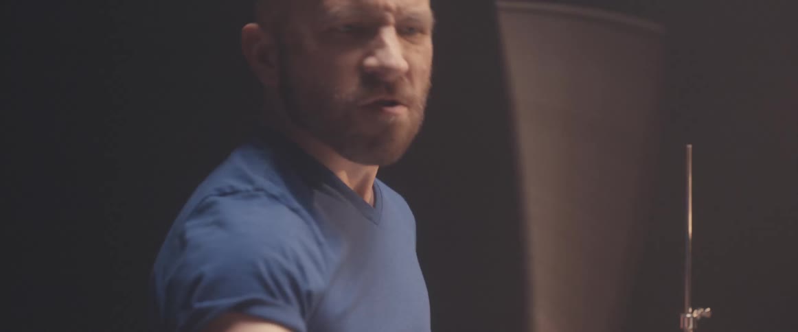 A man is playing the drums in a room