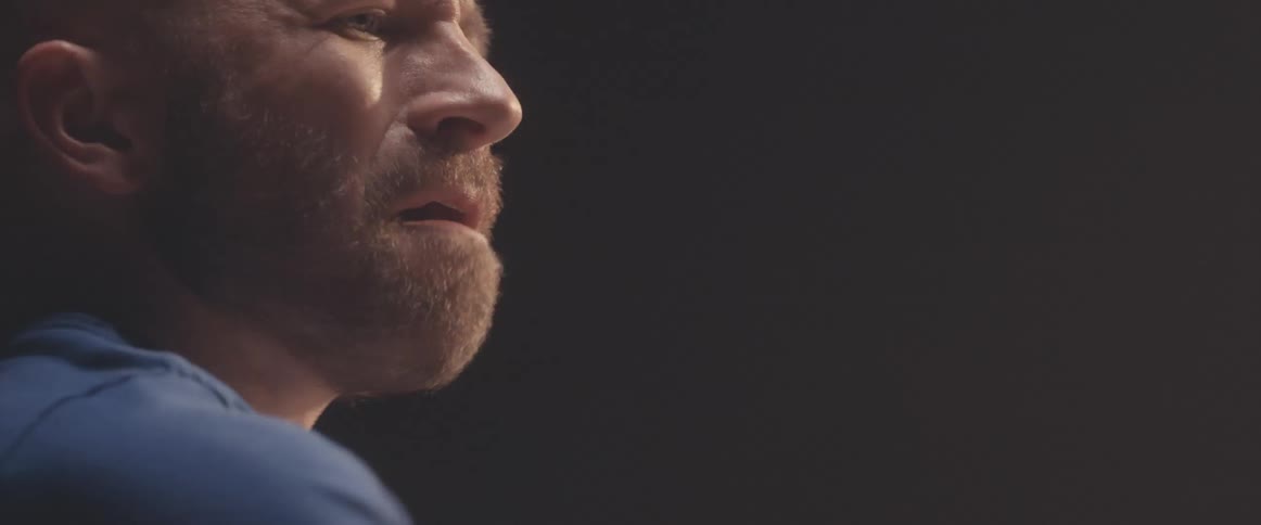 A man seems to practicing drums in a studio