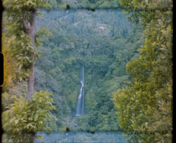 Water flows down a green hillside into a basin