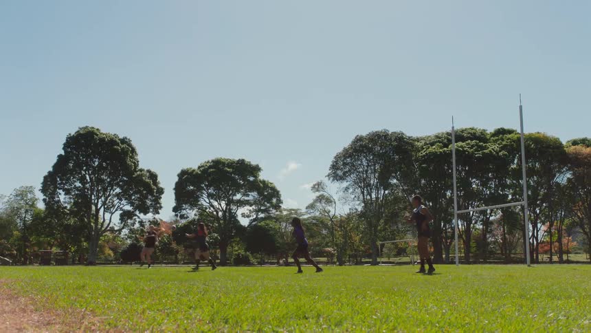 A group of girls are throwing a soccer ball to each other on a field