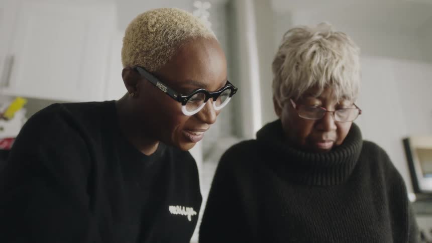 Two women talk together