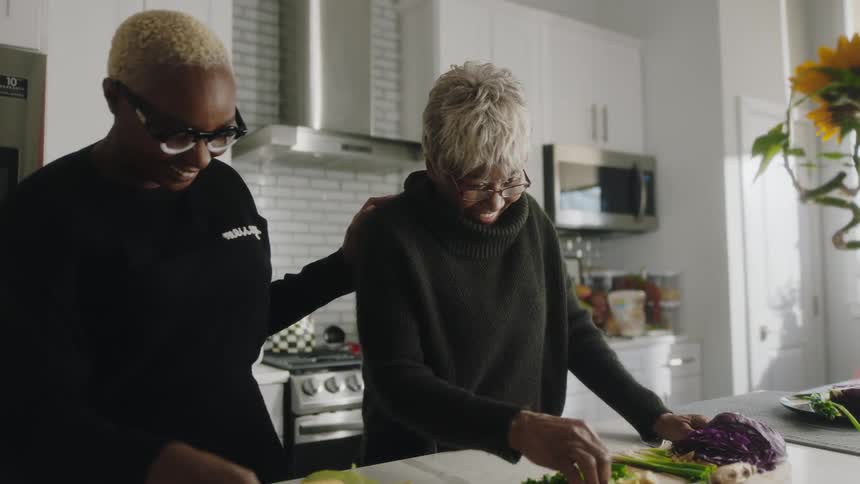 Two women prepare food in the kitchen