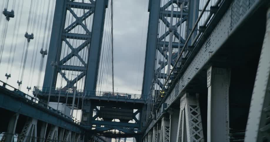 A suspension bridge sits on iron columns
