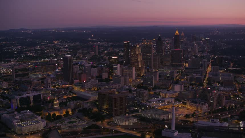Aerial view of city skyline with skyscrapers at dusk
