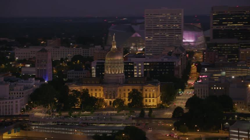 Aerial view of a downtown city during the night is displayed
