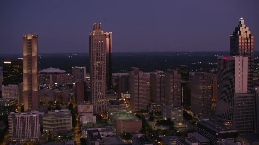 Buildings and skyscrapers are lit up at night in a big city