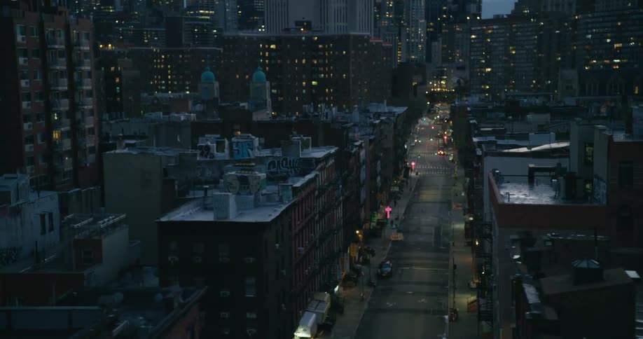Vehicle headlights light up a city at night