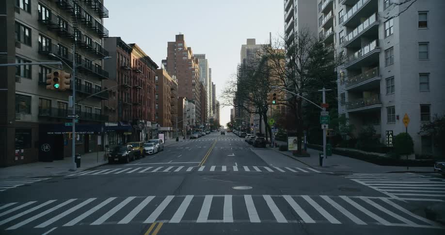 Traveling down a street surrounded by large buildings in a city
