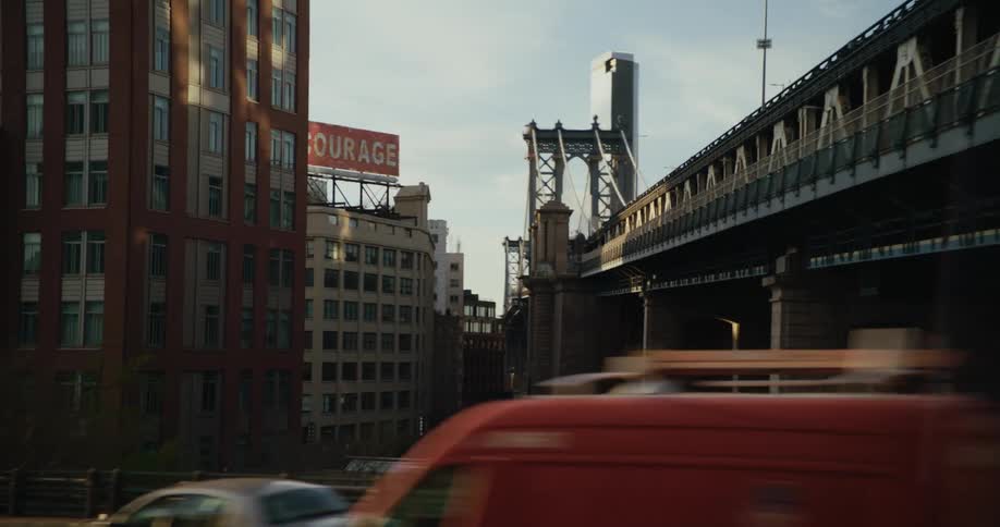 A large bridge through a metropolis during the day